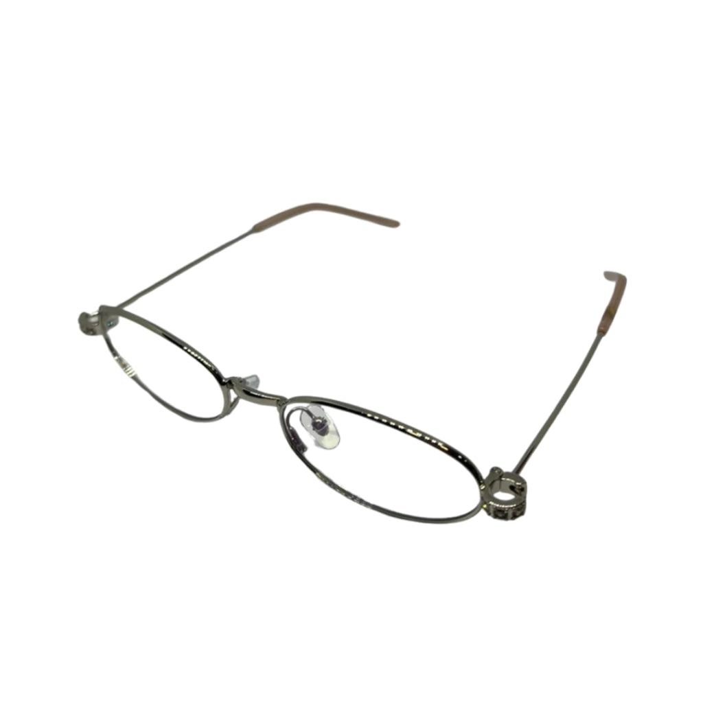 Armação de óculos feminina oval com detalhes metálicos e hastes finas, ideal para óculos de grau.
